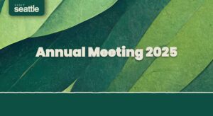 A green-toned background with overlapping leaves, a "Visit Seattle" logo in the top left, and bold white text in the center reading "Annual Meeting 2025.