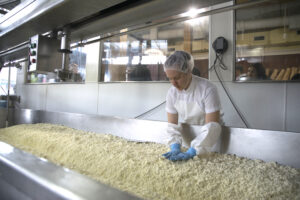 A worker making cheese curds at Beecher's Cheese.