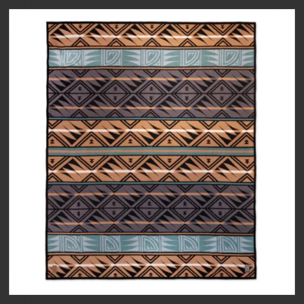 A rectangular rug featuring geometric patterns in black, tan, brown, and teal horizontal stripes, with triangles, diamonds, and zigzag designs. The rug has a white border and dark frame.