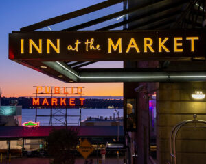Hotel sign with a twilight skyline in the backdrop