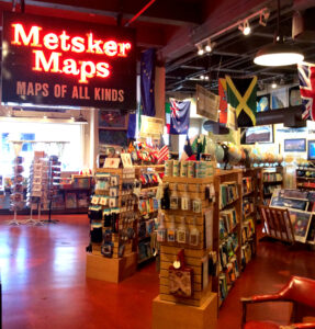 A glowing red neon sign saying Metsker Maps: Maps of All Kinds