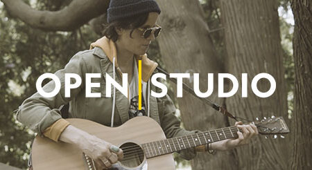 Person playing an acoustic guitar outdoors, wearing a beanie and sunglasses. The words "OPEN | STUDIO" are overlaid on the image. Forest background with large trees.