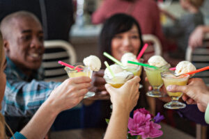 A group of people lifting glasses in cheer during a Savor Seattle Food Tour.