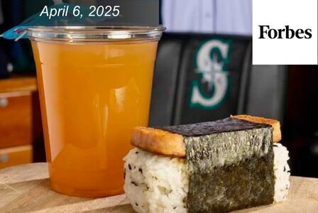 A cup of orange drink and a piece of spam musubi.