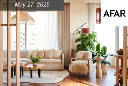 A modern, sunlit living room with a white sofa,