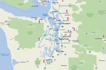 Map of Puget Sound, Washington, highlighting major cities like Seattle, Tacoma, and Olympia. It shows ferry routes, trails, airports, wineries, ferries, marinas, and parks. The map also indicates travel distances between key locations.