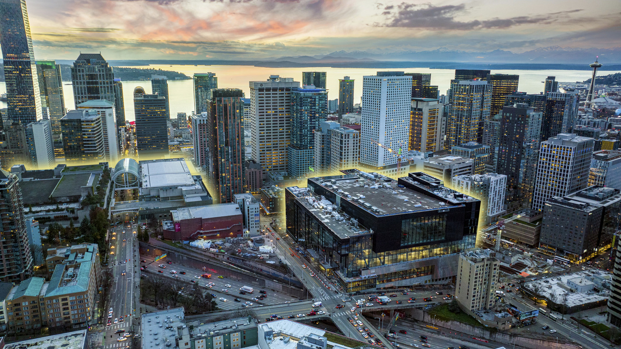 An aerial view of downtown Seattle, showing the proximity of Arch and Summit, two convention center buildings, outlined in a yellow glow for ease of visiblity.