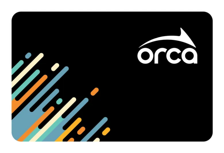 A depiction of the ORCA card transit pass. The pass is a black rectangle with rounded edges. In the bottom left corner are decorative lines in light blue, orange, turquoise, and cream. In the top right corner is the ORCA card logo in white.