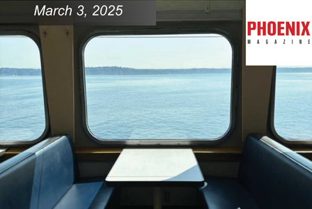Interior view from a ferry with empty seats and a table by a window overlooking a calm sea and distant shoreline.
