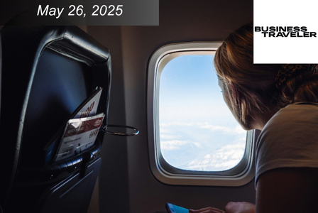 A person looks out the window of an airplane.
