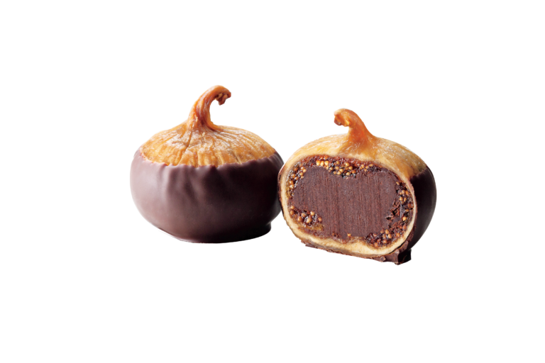 Two figs coated in chocolate, one whole and one cut in half to reveal a rich, dark interior. The cross-section shows a textured filling with small seeds, set against a plain background.